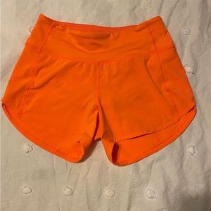 Lululemon  Size 2
“4 inch”  Speed Ups Mid Rise
Color: Highlight Orange
